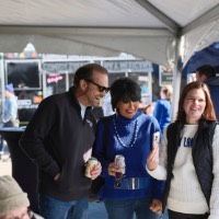 Woman showing President Mantella and man her phone